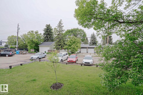 Spacious paved parking area with surrounding green space - 205 14903 92 Avenue Nw, Edmonton, AB 
