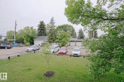 Spacious paved parking area with surrounding green space - 