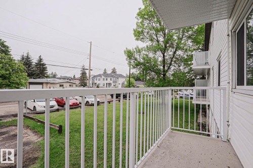 Private concrete balcony with white metal railings - 205 14903 92 Avenue Nw, Edmonton, AB 