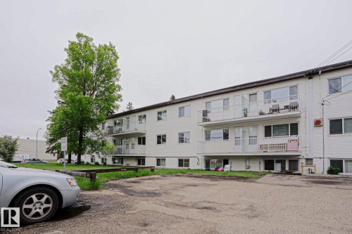 Multi-story building featuring white horizontal siding and multiple private balconies - 205 14903 92 Avenue Nw, Edmonton, AB 