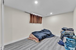Room with recessed lighting, light-toned walls, and wood-finish flooring - 