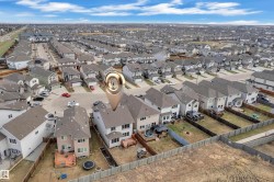 Aerial perspective showcasing a residential development with multiple detached properties - 