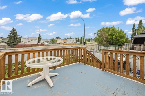 Spacious outdoor deck featuring wooden railings and steps - 8103 154 Avenue, Edmonton, AB 