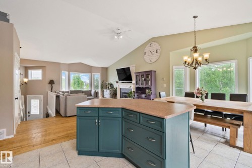 Kitchen island with teal cabinetry and light-toned countertop - 14 53122 Rge Road 14, Rural Parkland County, AB 