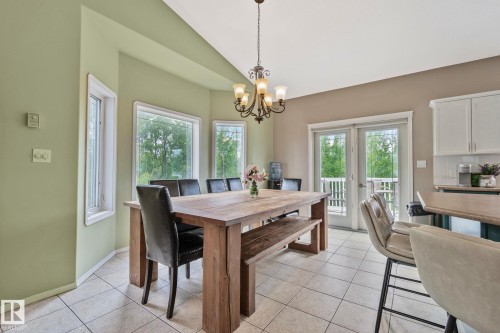 Dining area featuring light ceramic tile flooring and a bay window with multiple panes - 14 53122 Rge Road 14, Rural Parkland County, AB 