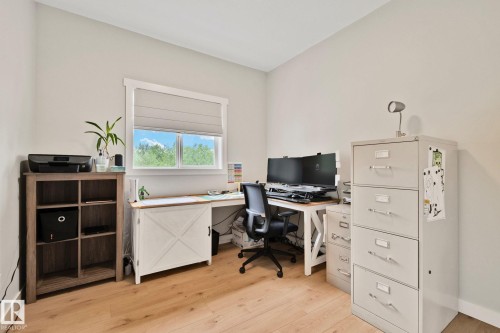 Neutral wall tones with light wood-finish flooring - 14 53122 Rge Road 14, Rural Parkland County, AB 