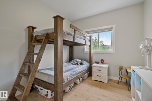 Light-filled room featuring wood-finish flooring and a single window with white trim - 14 53122 Rge Road 14, Rural Parkland County, AB 