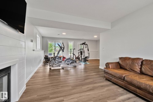 Spacious open-concept room with wood-finish flooring, recessed lighting, and white baseboards - 14 53122 Rge Road 14, Rural Parkland County, AB 