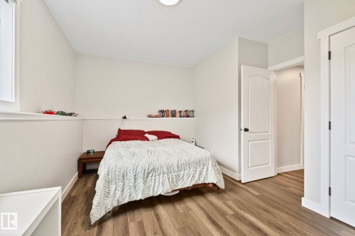 Bedroom with wood-finish flooring, light neutral wall color, and white trim - 14 53122 Rge Road 14, Rural Parkland County, AB 