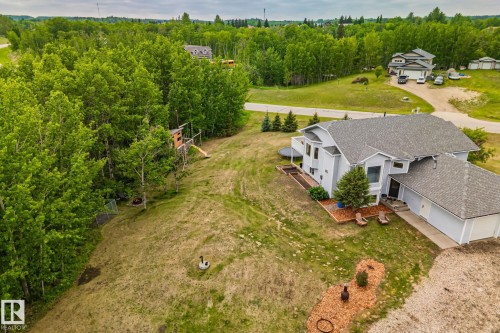 Contemporary residence featuring a light-colored exterior, an attached two-car garage, and multiple gabled rooflines - 14 53122 Rge Road 14, Rural Parkland County, AB 