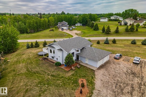 Light blue two-story residential structure featuring a multi-car attached garage and a bay window - 14 53122 Rge Road 14, Rural Parkland County, AB 