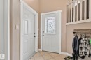 Entryway featuring a decorative glass panel door, durable tiled flooring, and a white baluster railing - 14 53122 Rge Road 14, Rural Parkland County, AB 