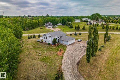 Spacious property featuring a light-colored exterior, an attached two-car garage, and a substantial driveway - 14 53122 Rge Road 14, Rural Parkland County, AB 