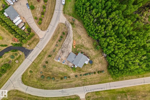 Aerial perspective of a property featuring a gray-roofed residence surrounded by natural landscapes - 14 53122 Rge Road 14, Rural Parkland County, AB 