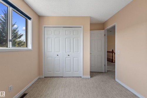 Room featuring light-colored walls and patterned carpet flooring - 5 20 Deerbourne Drive, St. Albert, AB 