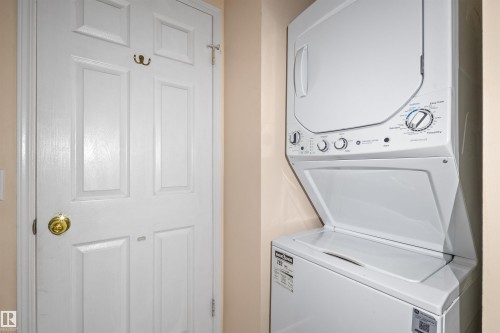 Included stacked laundry appliances with white finishes, featuring a top-loading washer and front-loading dryer - 5 20 Deerbourne Drive, St. Albert, AB 