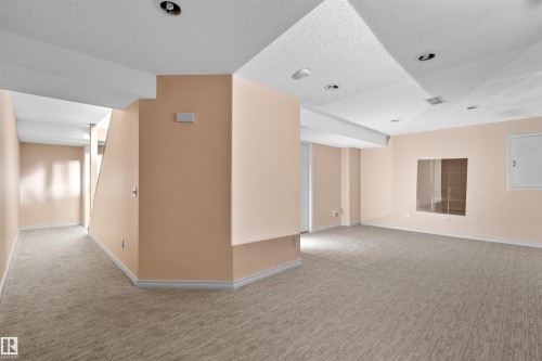 Expansive carpeted area with recessed lighting and a textured ceiling - 5 20 Deerbourne Drive, St. Albert, AB 