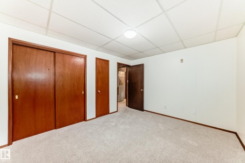 Room featuring light-toned carpeting, white walls, and a drop ceiling with recessed lighting - 12022 62 Street, Edmonton, AB 