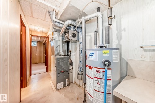 Utility area featuring a water heater, furnace, and exposed ductwork - 12022 62 Street, Edmonton, AB 