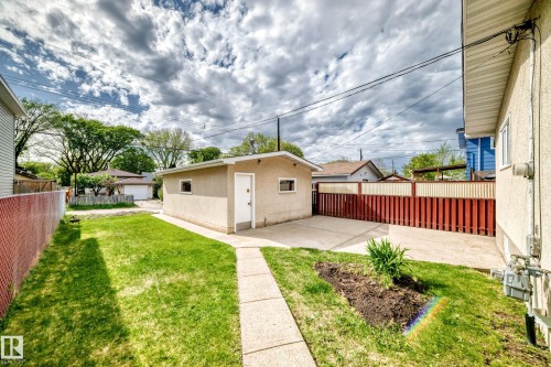 Detached garage with stucco exterior and white door - 12022 62 Street, Edmonton, AB 