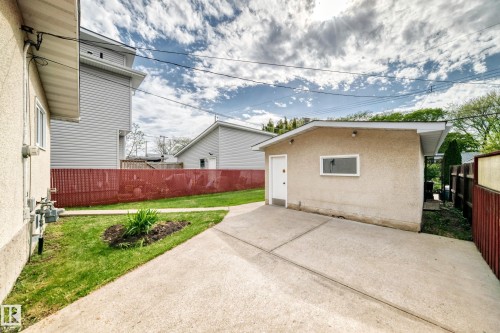 Detached stucco garage with a side entry door and a single window - 12022 62 Street, Edmonton, AB 