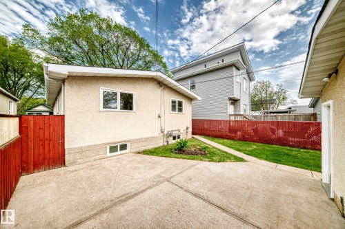 Concrete driveway leading to a manicured lawn area - 12022 62 Street, Edmonton, AB 
