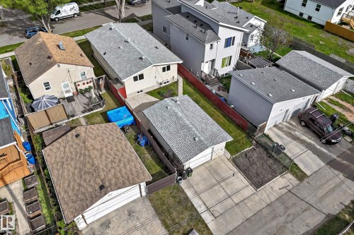 Detached single-family home with a wood deck and a separate detached garage with a driveway - 12022 62 Street, Edmonton, AB 