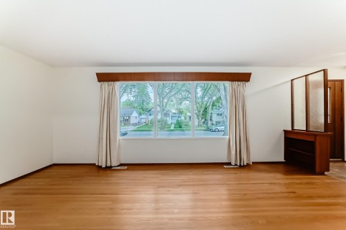 Bright interior space with wood-finish flooring - 12022 62 Street, Edmonton, AB 