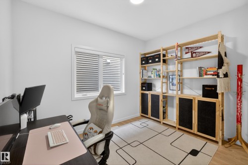 Room featuring light wood-finish flooring, a white ceiling with recessed lighting, and a window with horizontal blinds - 17023 45 Street, Edmonton, AB 