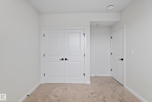 Neutral-toned carpeting and white walls provide a versatile backdrop - 17023 45 Street, Edmonton, AB 