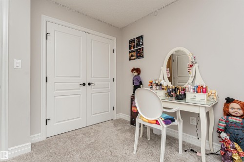 Large closet with double-panel interior doors with matte black hardware - 8744 223 Street Nw, Edmonton, AB 