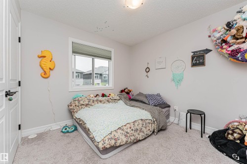 Carpeted room with a single window featuring horizontal blinds - 8744 223 Street Nw, Edmonton, AB 