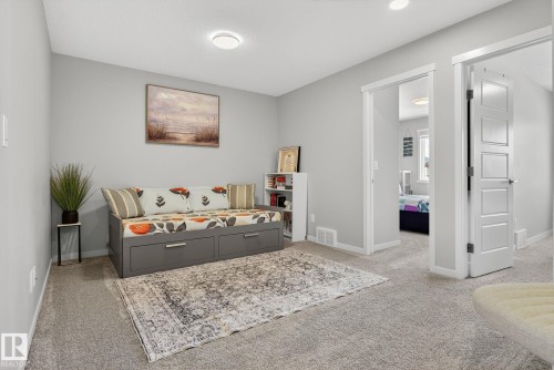 Carpeted room with light gray walls, featuring a built-in daybed with integrated storage drawers - 1213 16A Street, Edmonton, AB 