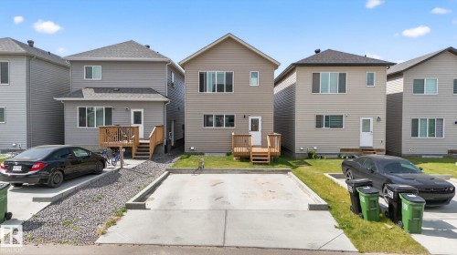 Contemporary two-story residence featuring light beige siding and a dark shingle roof - 1213 16A Street, Edmonton, AB 