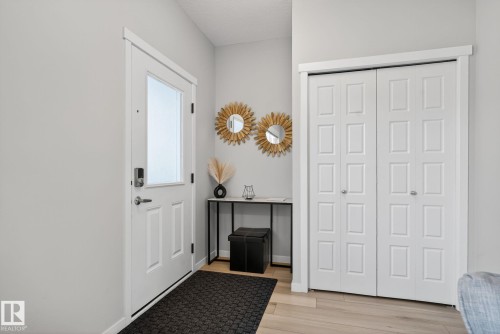Entryway featuring a white paneled door with a frosted glass insert and contemporary hardware - 1213 16A Street, Edmonton, AB 