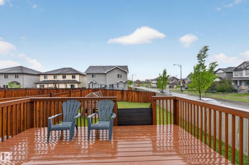 Spacious wood-finish deck with railing overlooking a fenced yard - 1404 25 Avenue, Edmonton, AB 