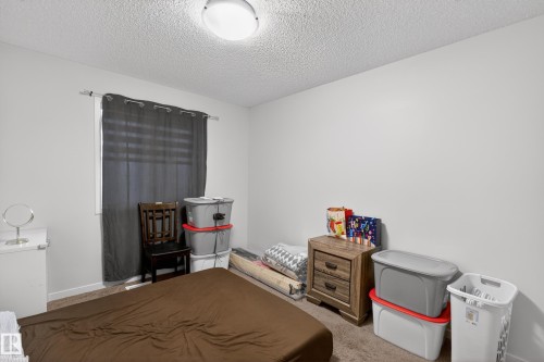Room featuring light gray walls and textured ceiling - 1404 25 Avenue, Edmonton, AB 