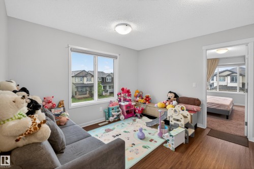 Interior room featuring wood-finish flooring and light gray wall paint - 1404 25 Avenue, Edmonton, AB 