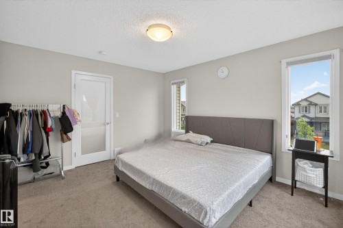 Spacious room with neutral gray walls and carpeting - 1404 25 Avenue, Edmonton, AB 