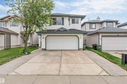 Two-story residence featuring light-colored siding and a dark shingled roof - 3519 22 Street Nw, Edmonton, AB 