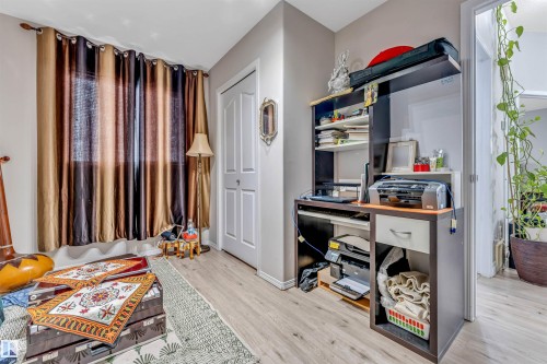 Light wood-finish flooring complements neutral wall tones - 3519 22 Street Nw, Edmonton, AB 