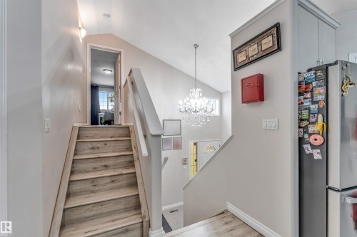 Split-level entry with wood-finish stairs and light grey walls - 3519 22 Street Nw, Edmonton, AB 
