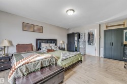 Spacious interior featuring wood-finish flooring, neutral wall tones, and a ceiling-mounted light fixture - 