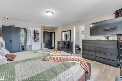 Bedroom featuring light wood-finish flooring and a ceiling-mounted light fixture - 