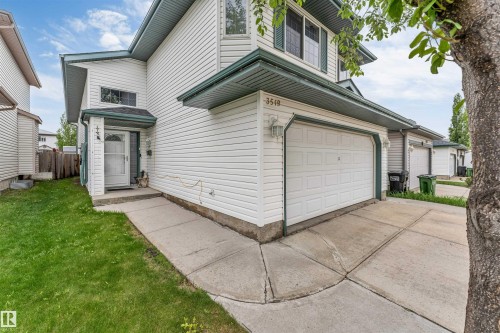 Exterior featuring white siding, a single-car garage, and a concrete driveway - 3519 22 Street Nw, Edmonton, AB 