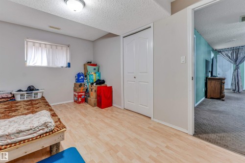 Light wood-finish flooring complements neutral wall tones - 3519 22 Street Nw, Edmonton, AB 