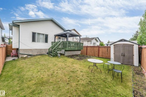 Spacious backyard featuring a sloped lawn and a fenced perimeter - 3519 22 Street Nw, Edmonton, AB 