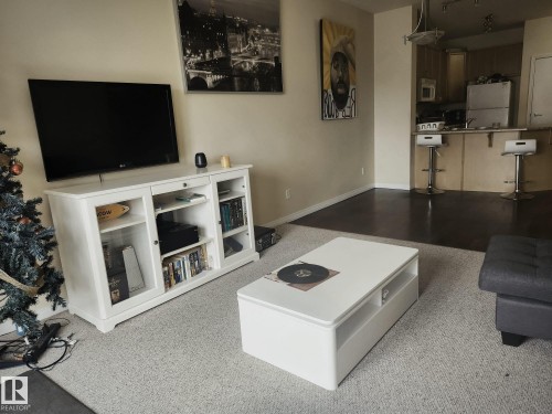 Open-concept living area with light-toned wall paint and recessed lighting - 425 4304 139 Avenue, Edmonton, AB 