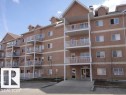 Multi-story residential building featuring a brick exterior and multiple private balconies with white railings - 425 4304 139 Avenue, Edmonton, AB 