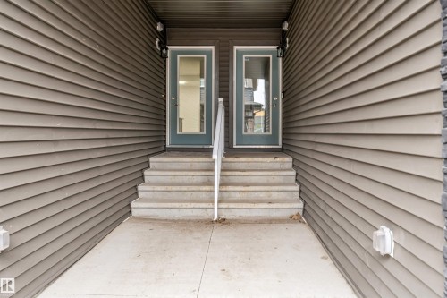 Dual entry doors with full glass panels and a central handrail - 45 2710 66 Street, Edmonton, AB 
